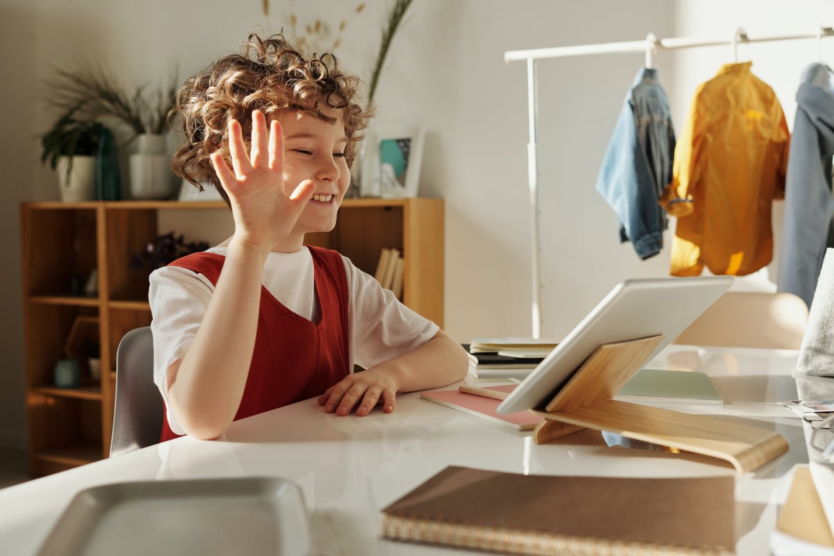 photo-of-child-smiling-while-using-tablet-computer-4145032